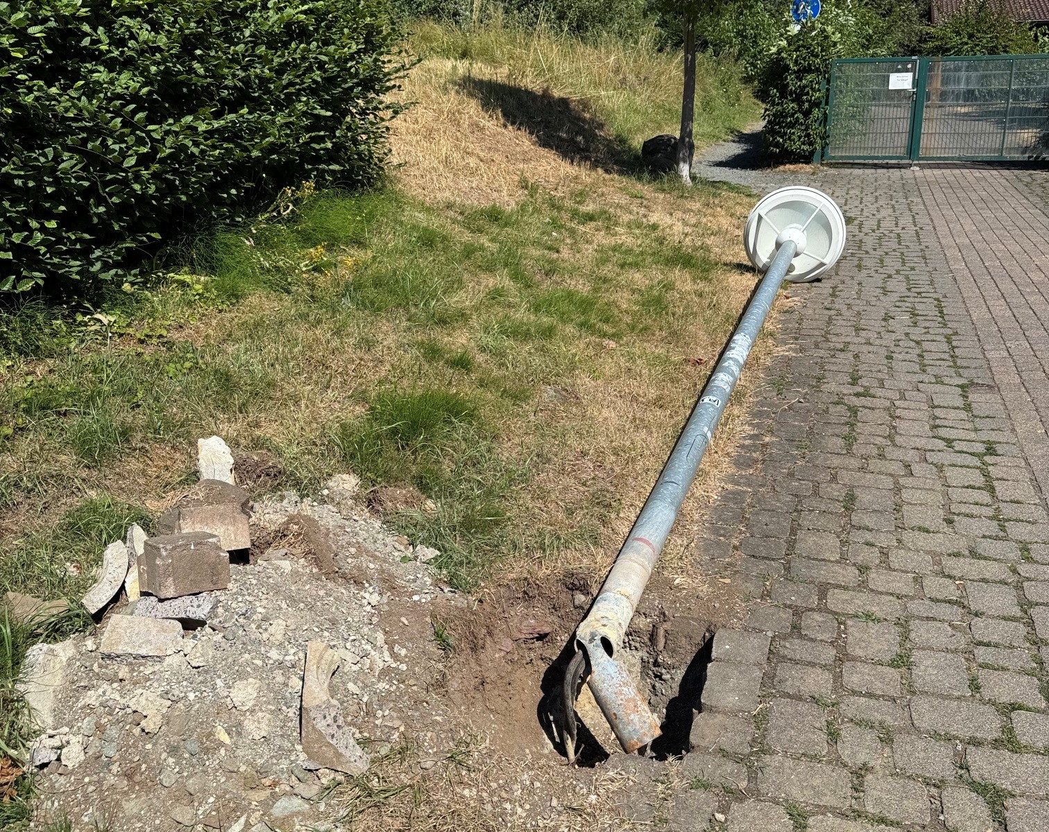 Zerstörte Straßenlaterne am Kindergarten Donsbach. Das Bild dient auch als Navigationselement und führt zum ganzen Artikel.