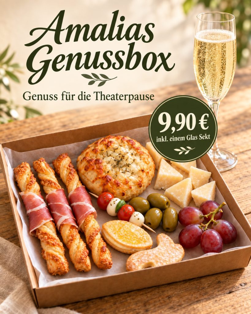 Käse, Weintrauben und kleine Snacks in einer Box, sowie ein Glas Sekt.